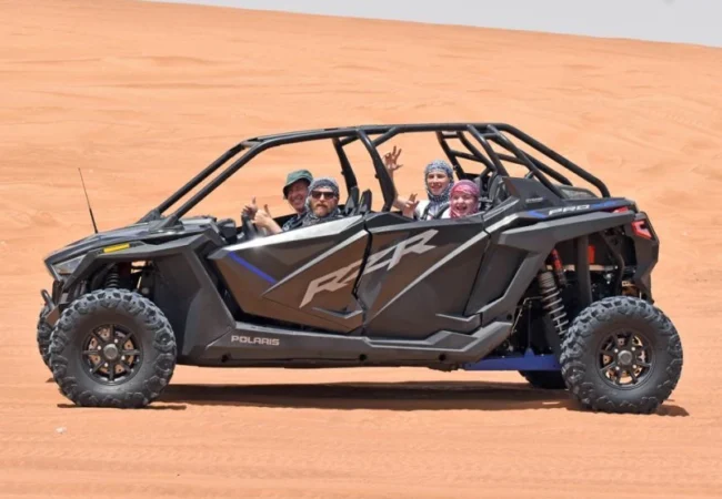Polaris RZR 1000 Turbo four-seater buggy climbing a dune outside Dubai